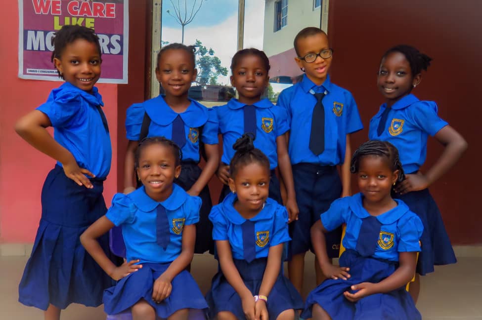 Cedar Harvesters pupils posing in front of a classroom